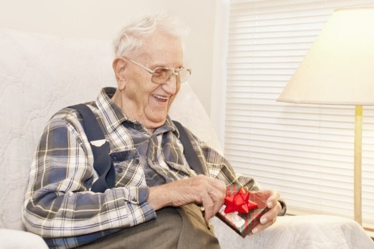 Elderly Man Opening Gift