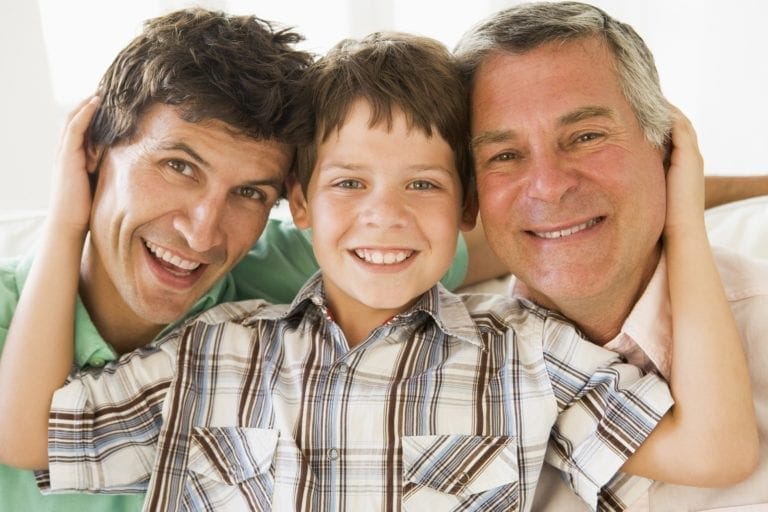 Grandfather With Son And Grandson Smiling.