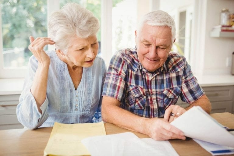 Seniors having trouble paying bills due to the common signs of Alzheimer's