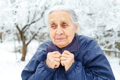 Elderly woman walking outside
