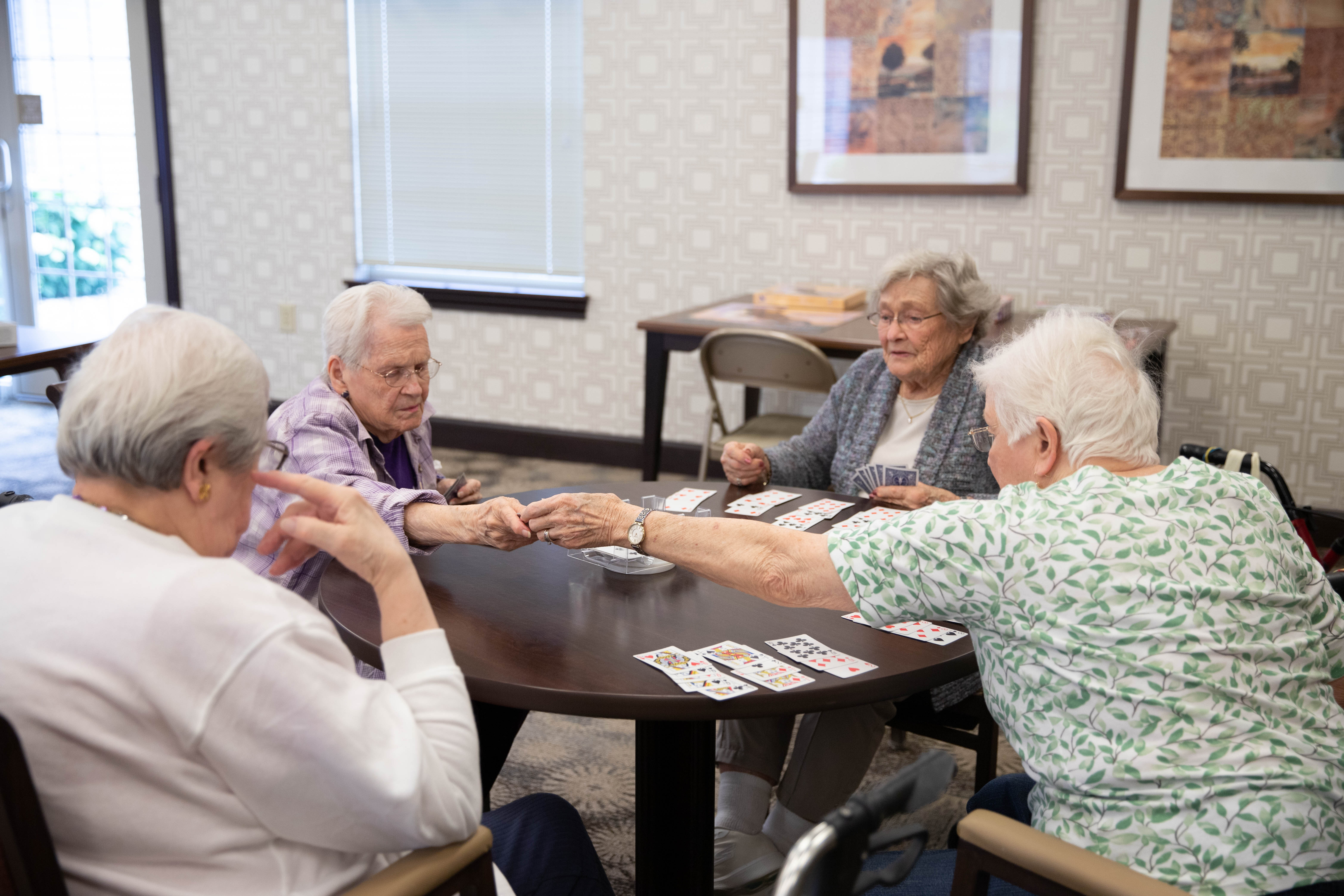 <span  class="uc_style_uc_tiles_grid_image_elementor_uc_items_attribute_title" style="color:#000000;">Residents playing cards together. </span>