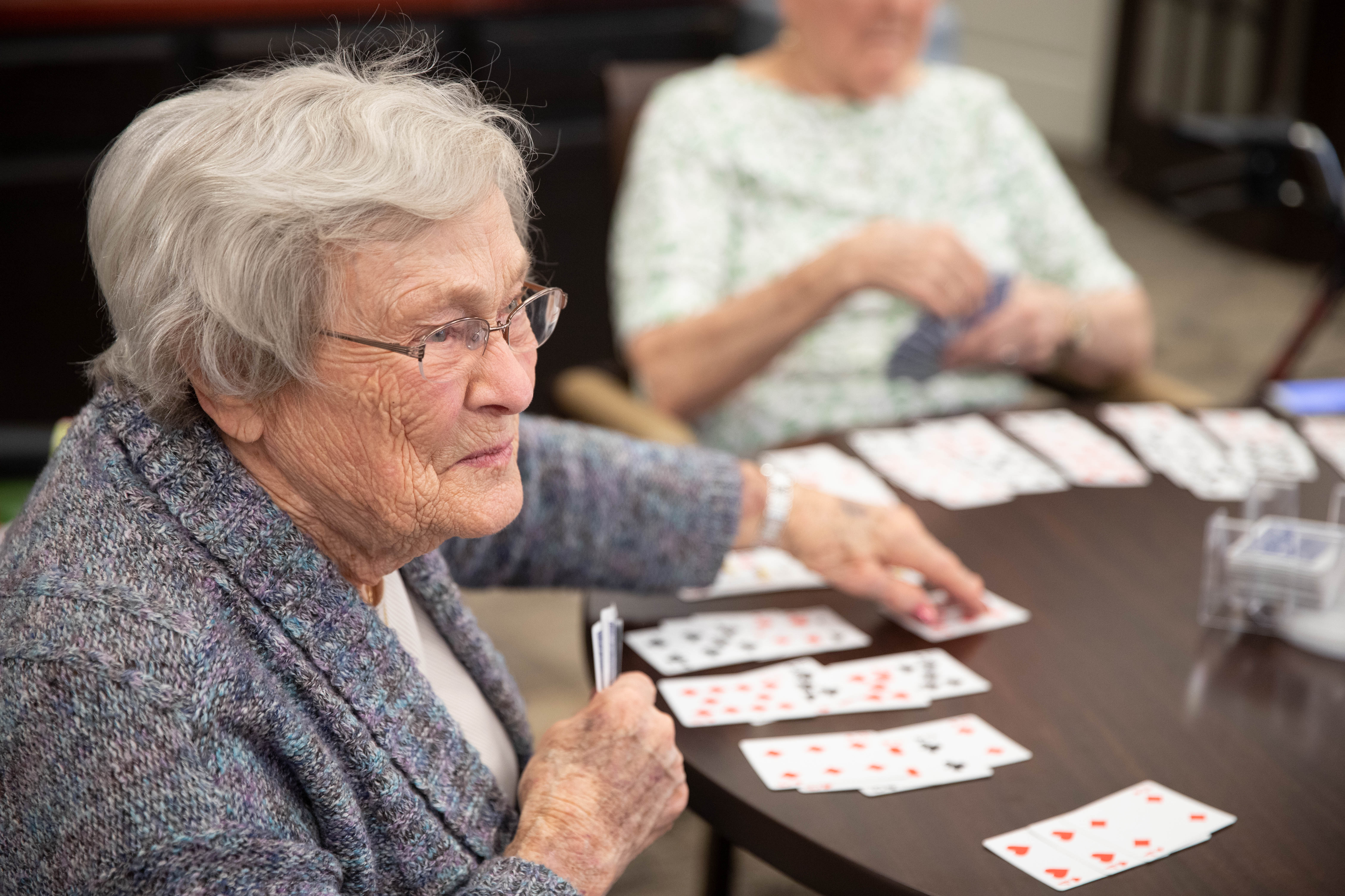 <span  class="uc_style_uc_tiles_grid_image_elementor_uc_items_attribute_title" style="color:#000000;">Residents playing cards at Aster Place</span>