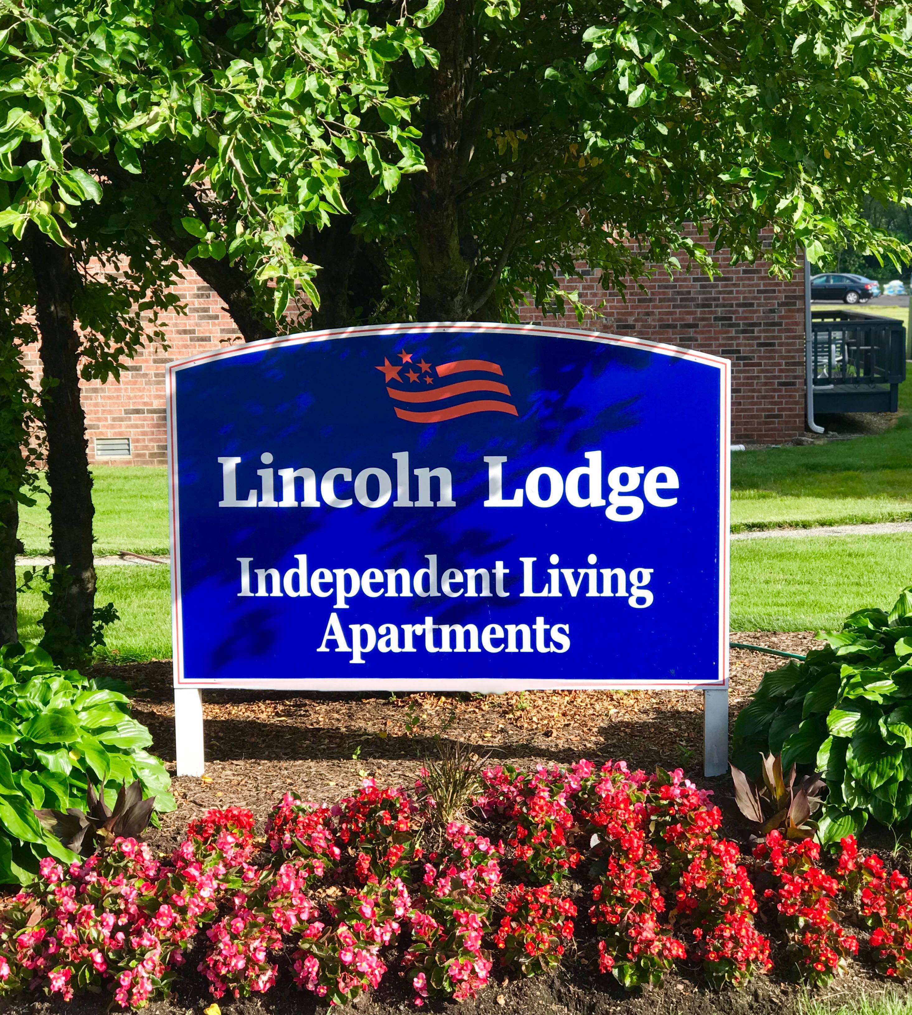 <span  class="uc_style_uc_tiles_grid_image_elementor_uc_items_attribute_title" style="color:#000000;">The exterior American Village Lincoln Lodge entry sign. </span>