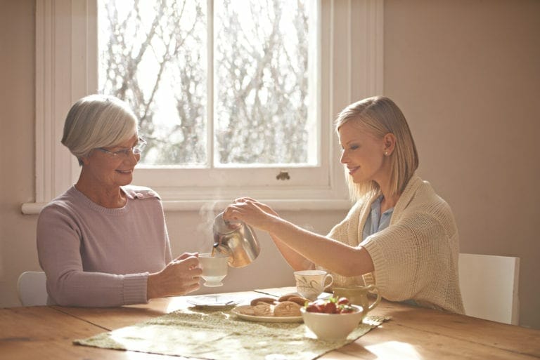 A cropped shot of a happy grandmother and granddaughter having tea