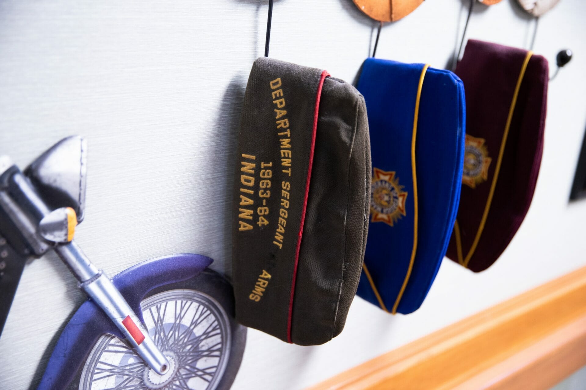 <span  class="uc_style_uc_tiles_grid_image_elementor_uc_items_attribute_title" style="color:#000000;">Allisonville Meadows Assisted Living art piece showing military service hats and a motorcycle.</span>