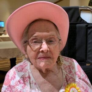 Centenarian Virginia Reiberg in pink hat and pink floral blouse