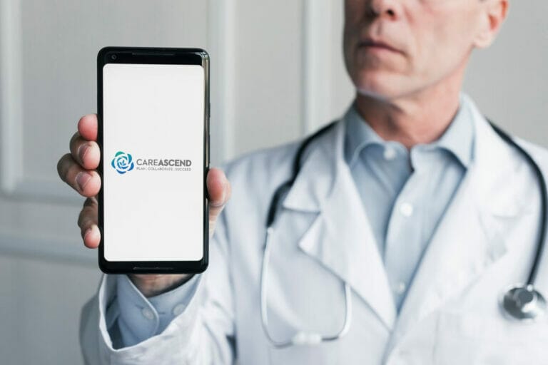 Doctor holding up phone showing CAREASCEND logo.