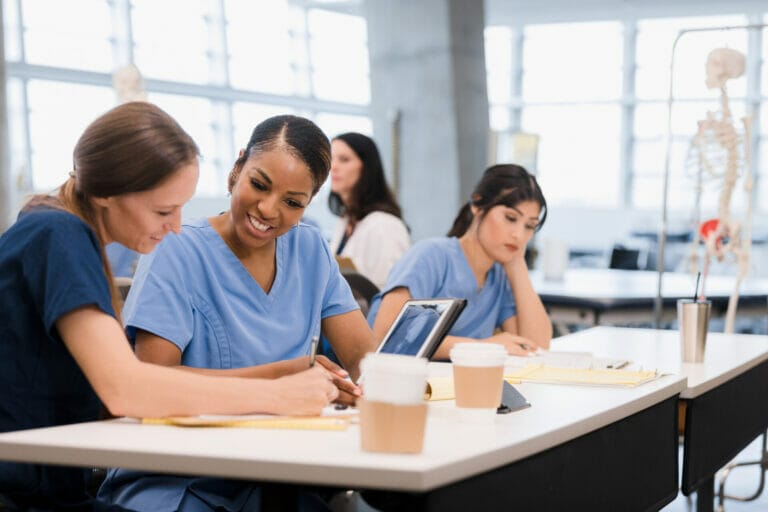 Two Mid Adult Female Nursing Students Co Operate On Classwork